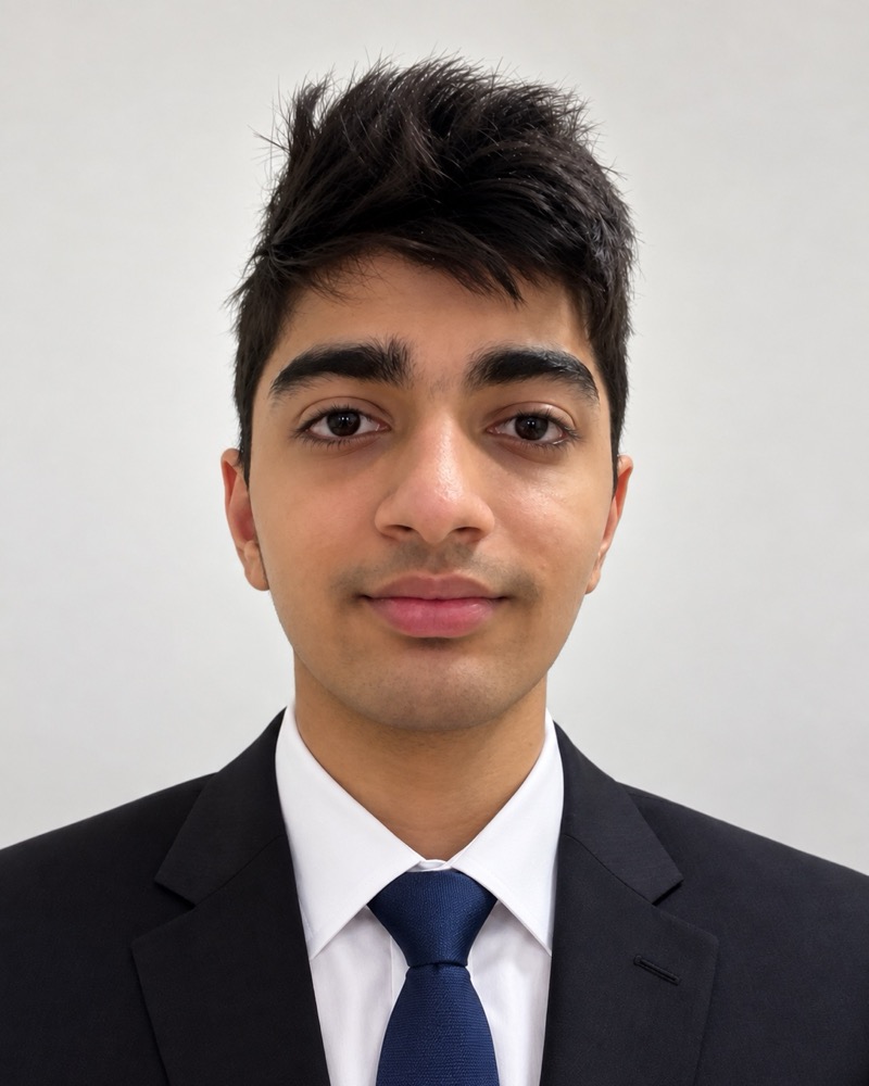 Advay Gahlot in a dark suit and blue tie